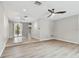 Open living area with tile and hardwood floors, and access to backyard at 1824 Southwood Ln, Clearwater, FL 33764