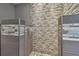 Walk in shower with pebble flooring and tile at 1824 Southwood Ln, Clearwater, FL 33764