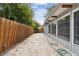 Long side yard with stone patio and wooden fence at 1824 Southwood Ln, Clearwater, FL 33764