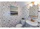 Stylish powder room with geometric wallpaper and modern fixtures at 18437 Purple Creek Ln, Lutz, FL 33549