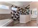 Spa-like bathroom with hexagon tile shower and soaking tub at 18437 Purple Creek Ln, Lutz, FL 33549