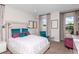 Bright bedroom with teal accents and ample natural light at 18437 Purple Creek Ln, Lutz, FL 33549