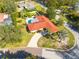 Single-story home with red tile roof, pool, and driveway at 2430 Roberta Ln, Clearwater, FL 33764