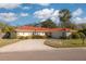 Single story home with red tile roof, driveway, and two-car garage at 2430 Roberta Ln, Clearwater, FL 33764