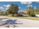 Single-story home with red tile roof, palm trees, and landscaped yard at 2430 Roberta Ln, Clearwater, FL 33764