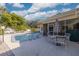Refreshing pool area with patio furniture and lush landscaping at 2430 Roberta Ln, Clearwater, FL 33764