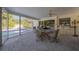 Screened porch with table, chairs, and pool view at 2430 Roberta Ln, Clearwater, FL 33764