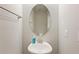 Clean and simple bathroom with an oval mirror and pedestal sink at 28523 Pleasant Bay Loop, Wesley Chapel, FL 33543