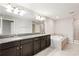 Bathroom with granite countertop, double sinks, and soaking tub at 28523 Pleasant Bay Loop, Wesley Chapel, FL 33543