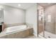 Bathroom with soaking tub and glass-enclosed shower at 28523 Pleasant Bay Loop, Wesley Chapel, FL 33543