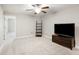 Bright bonus room with carpet, ceiling fan, and TV at 28523 Pleasant Bay Loop, Wesley Chapel, FL 33543