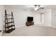 Spacious bonus room with carpeting, TV stand, and shelving at 28523 Pleasant Bay Loop, Wesley Chapel, FL 33543