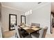 Formal dining room with dark wood table and gray chairs at 28523 Pleasant Bay Loop, Wesley Chapel, FL 33543
