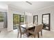 Bright dining room featuring a wooden table and six chairs, with access to the backyard at 28523 Pleasant Bay Loop, Wesley Chapel, FL 33543