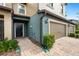 Townhome entry with black door and brick walkway at 28523 Pleasant Bay Loop, Wesley Chapel, FL 33543