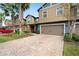 Two-story townhome with a red car parked in the driveway at 28523 Pleasant Bay Loop, Wesley Chapel, FL 33543