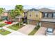 Two-story townhome with two-car garage and nicely landscaped front yard at 28523 Pleasant Bay Loop, Wesley Chapel, FL 33543