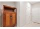 Hallway with wood storage cabinet and two doors at 28523 Pleasant Bay Loop, Wesley Chapel, FL 33543