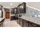 Modern kitchen with dark wood cabinets and a stylish backsplash at 28523 Pleasant Bay Loop, Wesley Chapel, FL 33543