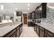 Modern kitchen with dark cabinets, granite counters, and stainless steel appliances at 28523 Pleasant Bay Loop, Wesley Chapel, FL 33543