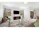 Living room with gray sofas, glass coffee table, and sliding doors at 28523 Pleasant Bay Loop, Wesley Chapel, FL 33543