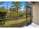 Screened patio overlooking a wooded backyard at 28523 Pleasant Bay Loop, Wesley Chapel, FL 33543
