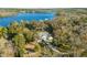 House nestled in lush greenery near a lake at 31445 Amberlea Rd, Dade City, FL 33523