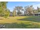 Expansive backyard with large oak trees and grassy area at 31445 Amberlea Rd, Dade City, FL 33523