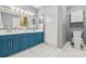 Modern bathroom with blue vanities and a shower at 31445 Amberlea Rd, Dade City, FL 33523