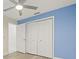 Bedroom with light blue walls and double door closet at 31445 Amberlea Rd, Dade City, FL 33523