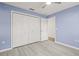 Light blue bedroom with wood-look floors and large closet at 31445 Amberlea Rd, Dade City, FL 33523
