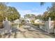White house with gated entrance and long driveway at 31445 Amberlea Rd, Dade City, FL 33523