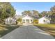 White house with long driveway, palm trees, and green lawn at 31445 Amberlea Rd, Dade City, FL 33523