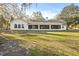House exterior showcasing the back of the home and a large covered porch at 31445 Amberlea Rd, Dade City, FL 33523