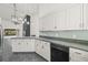 Modern kitchen with white cabinets and granite countertops at 31445 Amberlea Rd, Dade City, FL 33523