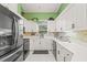 White kitchen with green accent wall and quartz countertops at 31445 Amberlea Rd, Dade City, FL 33523
