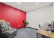 Home office with red accent wall and comfortable recliner at 31445 Amberlea Rd, Dade City, FL 33523