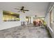 Spacious screened porch with tile flooring, wicker furniture, and ceiling fans at 31445 Amberlea Rd, Dade City, FL 33523