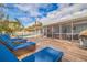 Spacious backyard with pool, deck, lounge chairs, and screened patio at 3282 Honeysuckle Rd, Largo, FL 33770