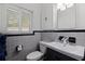 Bathroom with toilet, sink, and gray tile finishes at 3282 Honeysuckle Rd, Largo, FL 33770