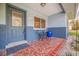 Front porch with terracotta tile flooring and a small bistro set at 3282 Honeysuckle Rd, Largo, FL 33770