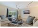 Spacious living room showcasing comfortable seating, a large TV, and access to a lanai and pool at 3282 Honeysuckle Rd, Largo, FL 33770
