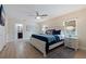 Main bedroom with a king-size bed, ample natural light, and an ensuite bathroom at 3282 Honeysuckle Rd, Largo, FL 33770