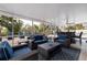 Comfortable screened patio furnished with wicker seating and coffee table at 3282 Honeysuckle Rd, Largo, FL 33770