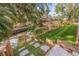 Landscaped waterfront area with artificial turf and stone pathway at 3282 Honeysuckle Rd, Largo, FL 33770