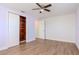 Bedroom with ceiling fan, hardwood floors and large closet at 3445 Briar Cliff Dr, Holiday, FL 34691