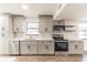 Updated kitchen with gray shaker cabinets, quartz countertops, and stainless steel appliances at 3721 9Th S Ave, St Petersburg, FL 33711