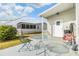 Small back patio with table and chairs, and partial view of the community at 37538 New Horizons Blvd, Zephyrhills, FL 33541