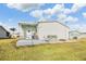 Backyard with a patio, clothesline, and lawn at 37538 New Horizons Blvd, Zephyrhills, FL 33541