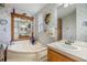 Bathroom with soaking tub, double vanity, and floral wallpaper at 37538 New Horizons Blvd, Zephyrhills, FL 33541